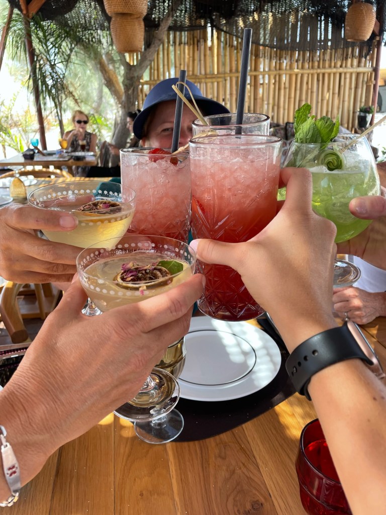 Drinks with friends at Black Sand Beach Club in Santorini, Greece