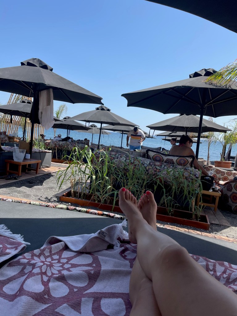 Black sand beach club in Santorini, Greece