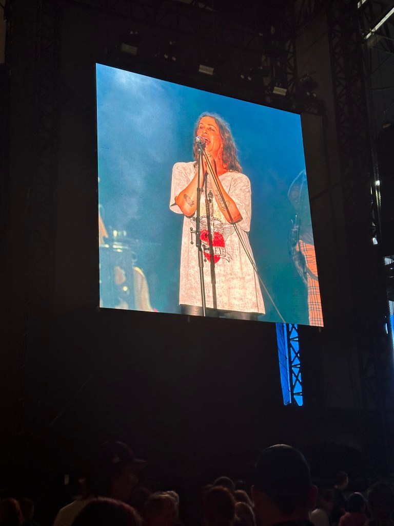 Alanis Morrisette signing on big screen at Sea Bright stage at Oceans Calling Festival 2023