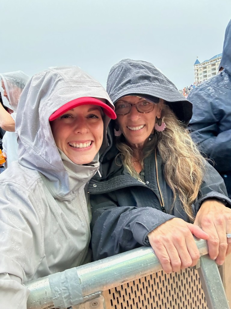 Friends in rain jackets at Ocean Calling Festival in Ocean City, Maryland