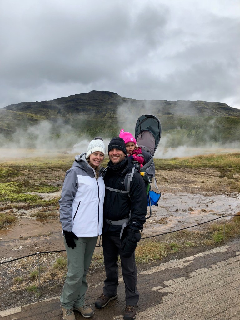 family picture in front of geysir in Iceland