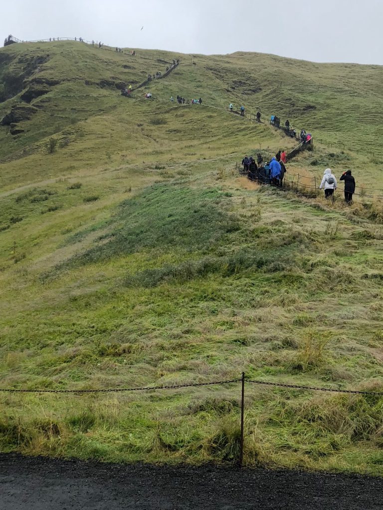 steep walking trail up to the top of skogafoss waterfall Iceland