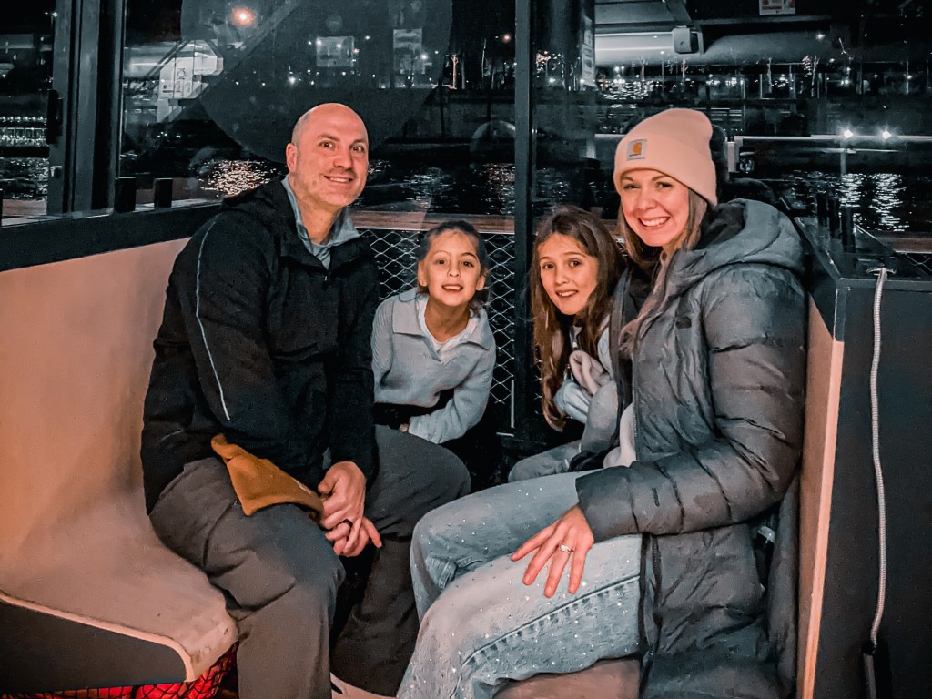 Family picture taken on a river cruise on the Seine River in Paris, France 